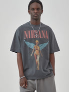 Schwarzes Nirvana-T-Shirt mit anatomischem Engel-Design, getragen von einem Mann. Perfekt für Grunge-Mode, Streetwear und Musikfans.