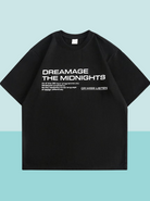 Schwarzes T-Shirt mit weißem Aufdruck "DREAMAGE THE MIDNIGHTS", lässiger Stil, Unisex, ideal für Streetwear und modische Outfits.