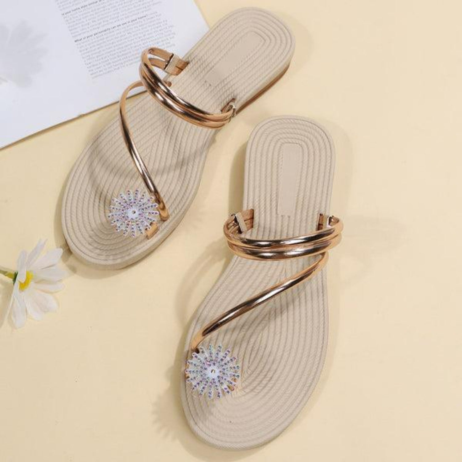 Beige Sandalen mit goldenen Riemen und Blumenverzierung, ideal für Sommermode. Damen-Sandalen, bequem, stilvoll, trendige Fußbekleidung.