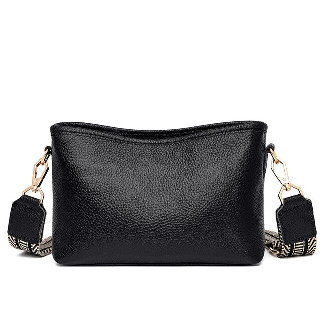 Elegante schwarze Lederhandtasche mit verstellbarem Schultergurt, ideal für Damenmode. Perfekt für Alltag und besondere Anlässe.