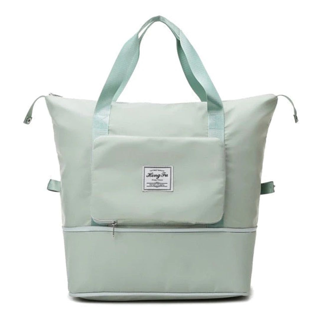 Mintgrüne Wickeltasche mit großem Hauptfach, Reißverschlusstaschen und robusten Tragegriffen. Ideal für Eltern unterwegs.