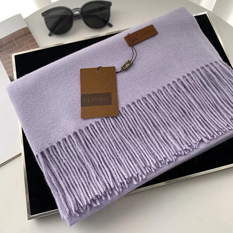 Lila Kaschmirschal mit Fransen, luxuriös und weich, ideal für stilvolle Wintermode. Perfektes Accessoire für Damen. Hochwertige Verarbeitung.