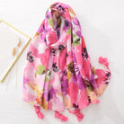 Bunter Blumenschal mit Quasten, ideal für Frühling und Sommer. Hochwertiger Stoff, lebendige Farben, modisches Accessoire für Damen.