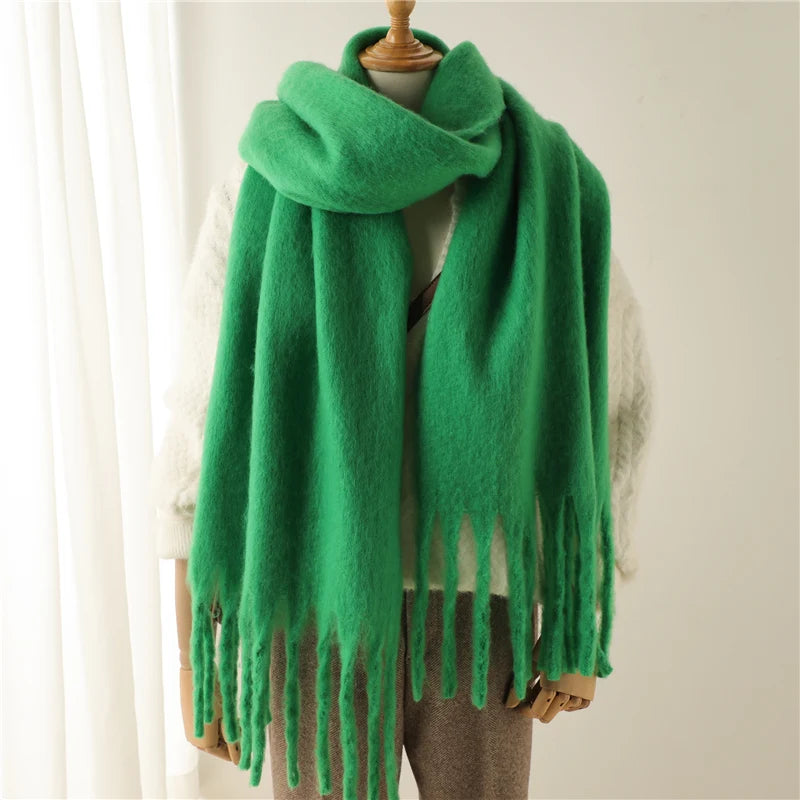 Grüner Schal aus weichem, flauschigem Material mit Fransen, ideal für kalte Wintertage. Modisches Accessoire für Damen und Herren.