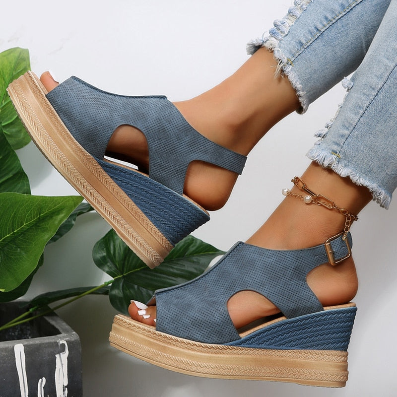 Blaue Keilsandalen mit offenem Zeh und Schnallenverschluss, kombiniert mit Jeans. Perfekt für Sommermode und lässige Outfits.