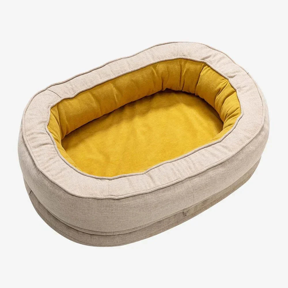 Beiges Hundebett oval, gelbes Innenfutter, waschbar, gemütlich, Haustierbedarf.