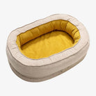 Beiges Hundebett oval, gelbes Innenfutter, waschbar, gemütlich, Haustierbedarf.