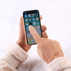 Handschuhe mit Touchscreen-Funktion, braun, halten ein Smartphone. Ideal für Winter, kompatibel mit iPhone, warmes Fleece-Futter, stilvoll und praktisch.