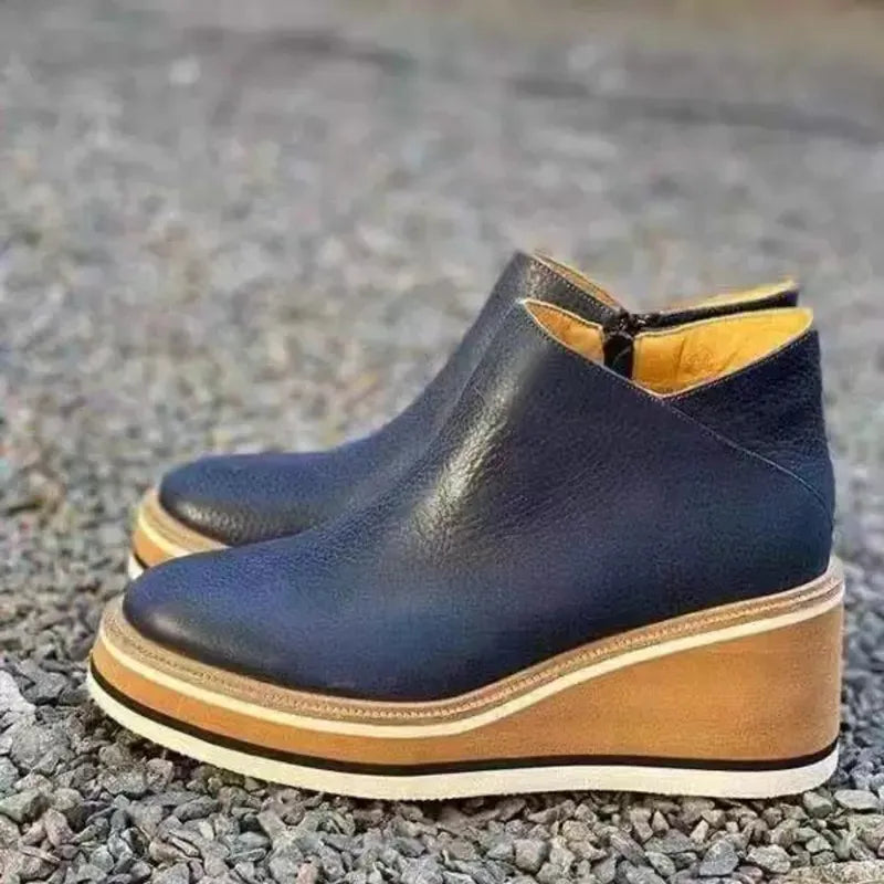 Damen-Stiefeletten aus schwarzem Leder mit Keilabsatz, modisch und bequem, ideal für Herbst und Winter. Perfekt für stilvolle Alltagslooks.