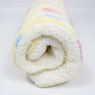 Weiches, flauschiges Handtuch, weiß mit bunten Streifen, aus Baumwolle, ideal für Badezimmer.