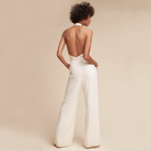 Eleganter weißer Jumpsuit mit Rückenausschnitt, ärmellos und weit geschnitten. Perfekt für stilvolle Anlässe und moderne Mode-Looks.