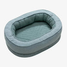 Ovales, blaues Hundebett aus Stoff, gemütlich und waschbar, ideal für kleine Hunde.