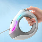 Handgehaltene automatische Hundeleine, grau, ergonomisch, LED-Licht, für Spaziergänge.