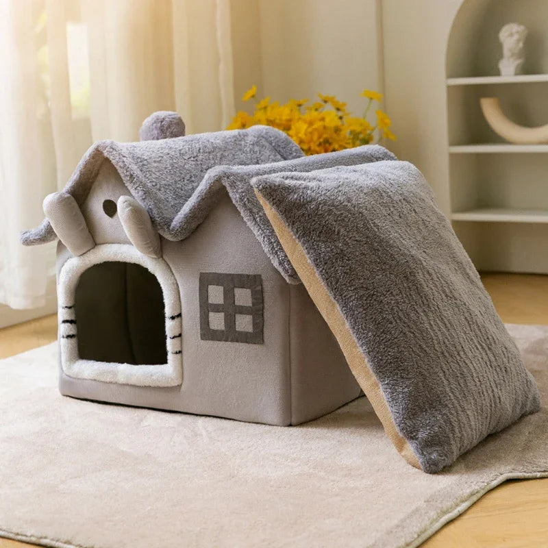 Graues Katzenhaus aus Plüsch, gemütlich, mit Kissen, idealer Rückzugsort für Haustiere.