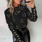 Elegante Damenbluse mit Herzmuster, langen Ärmeln und goldenen Knöpfen. Perfekt für Frühling und Herbst. Modische, lässige Damenmode.