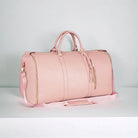 Rosa Weekender-Tasche aus Leder mit Schulterriemen, stilvoll und geräumig für Reisen.