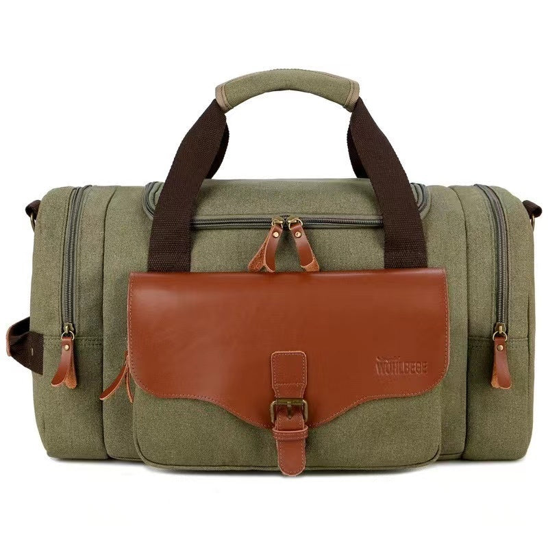 Grüne Canvas-Reisetasche mit braunen Lederakzenten, robust und stilvoll für Reisen.