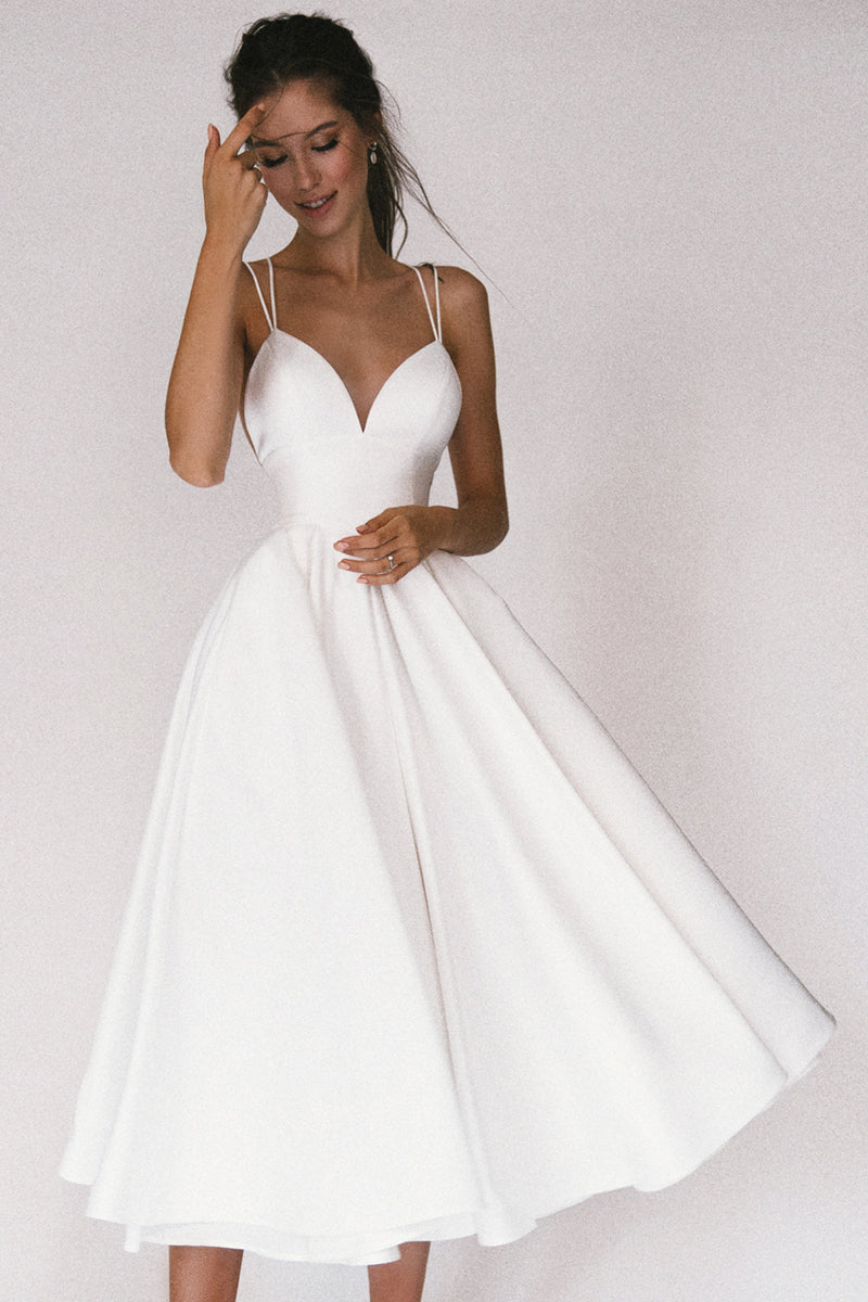 Elegantes weißes Satin-Midikleid mit Spaghettiträgern, herzförmigem Ausschnitt und fließendem Rock. Perfekt für Hochzeiten und besondere Anlässe.