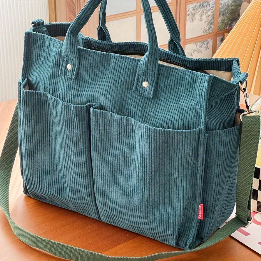 Grüne Cord-Umhängetasche mit mehreren Außentaschen, ideal für den Alltag. Stilvolle und praktische Handtasche für Damen.