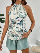 Damen Sommerbluse mit tropischem Muster, ärmellos, weiß-grün, lässig, modisch.