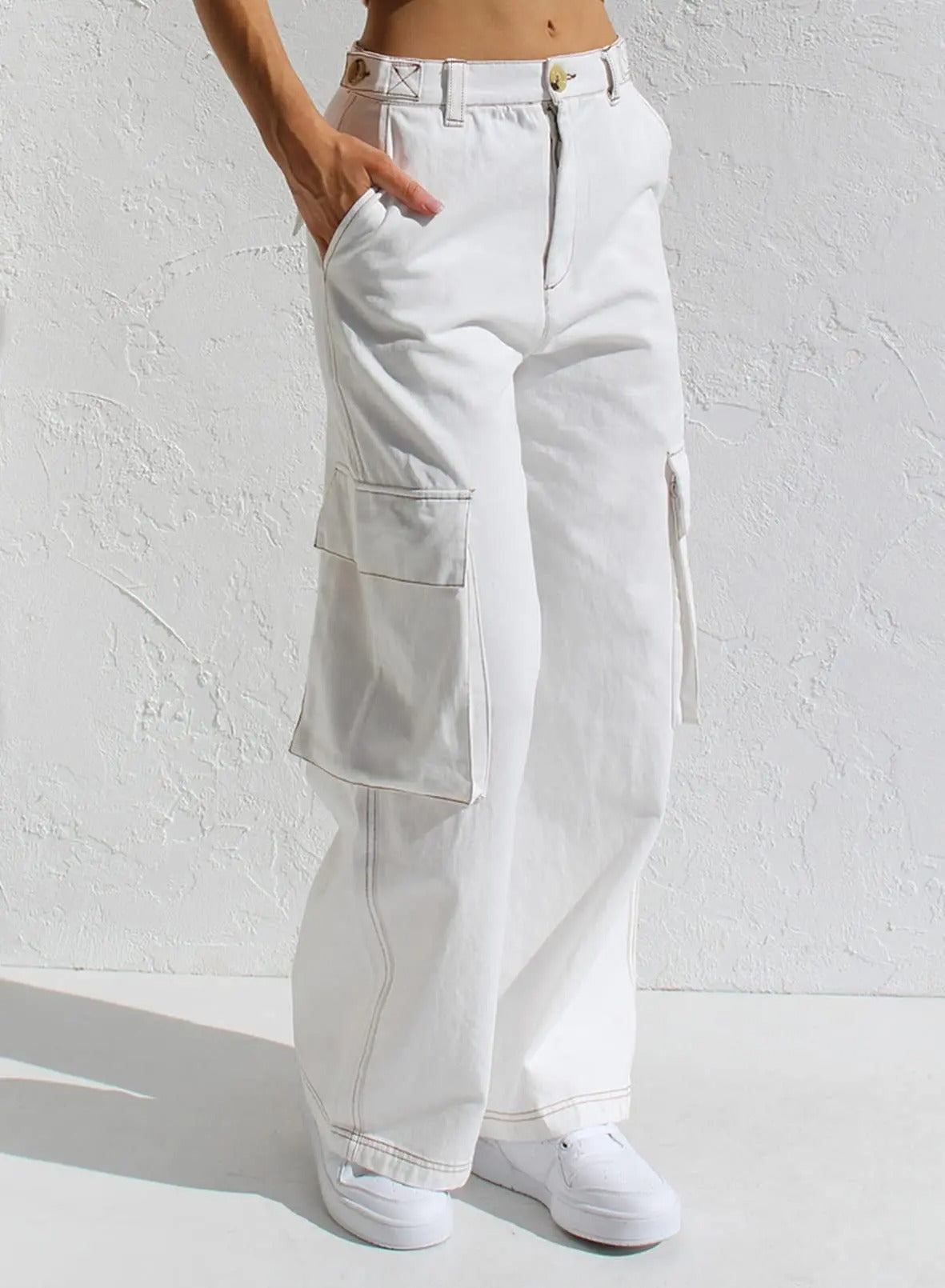 Weiße Cargo-Hose für Damen mit weitem Bein und großen Seitentaschen, ideal für lässige Outfits. Perfekt kombinierbar mit Sneakers.