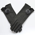 Elegante graue Damenhandschuhe aus Wolle mit stilvollen Kunstfell-Pompons, ideal für Wintermode und kaltes Wetter. Perfekt für stilvolle Outfits.