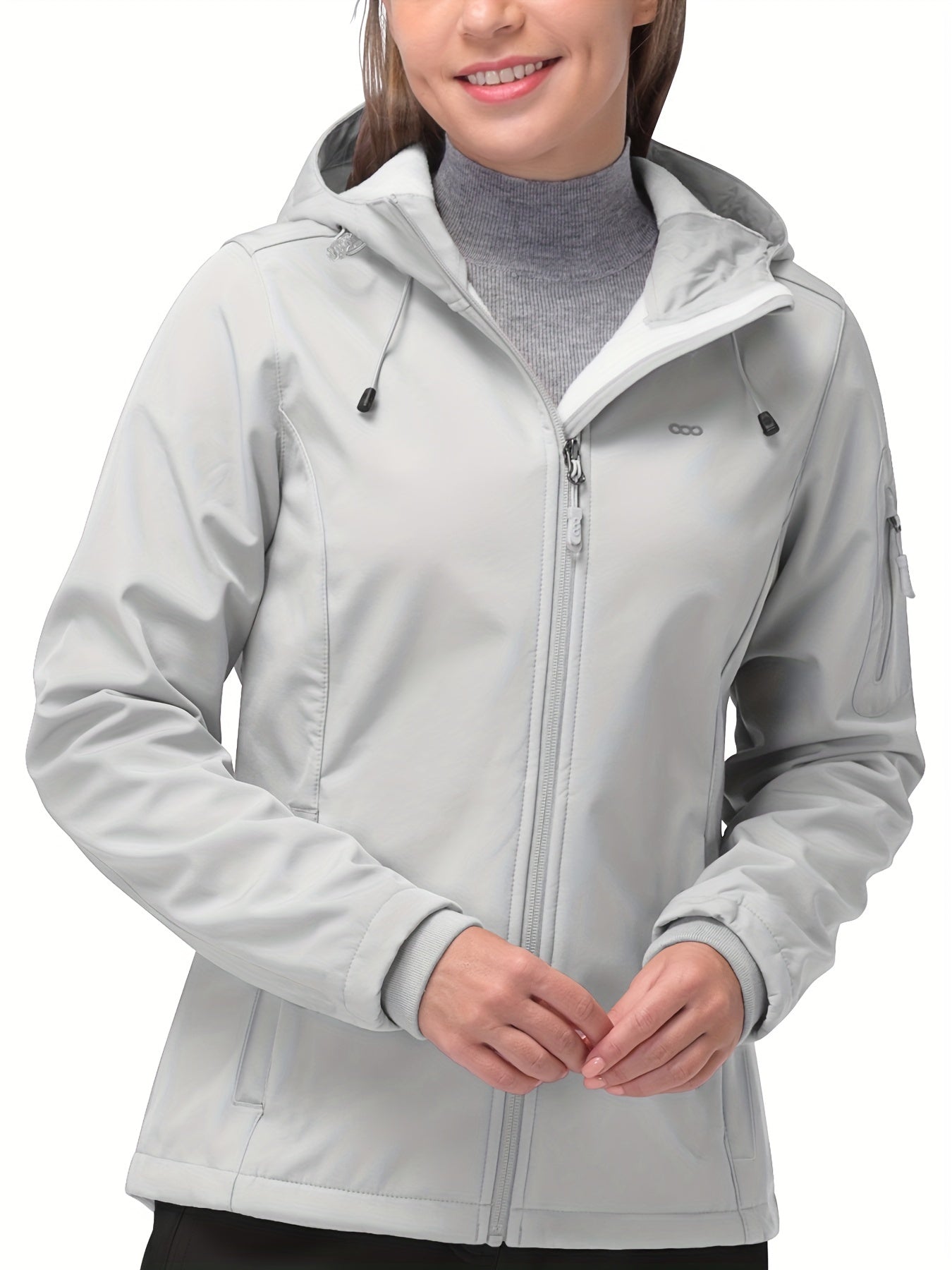 Damen-Softshelljacke in Hellgrau mit Kapuze, Reißverschluss und Seitentaschen. Ideal für Outdoor-Aktivitäten, wind- und wasserabweisend.