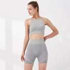 Graues Sportset für Damen, bestehend aus kurzem Top und Shorts. Ideal für Fitness, Yoga und Training. Atmungsaktiv und bequem.