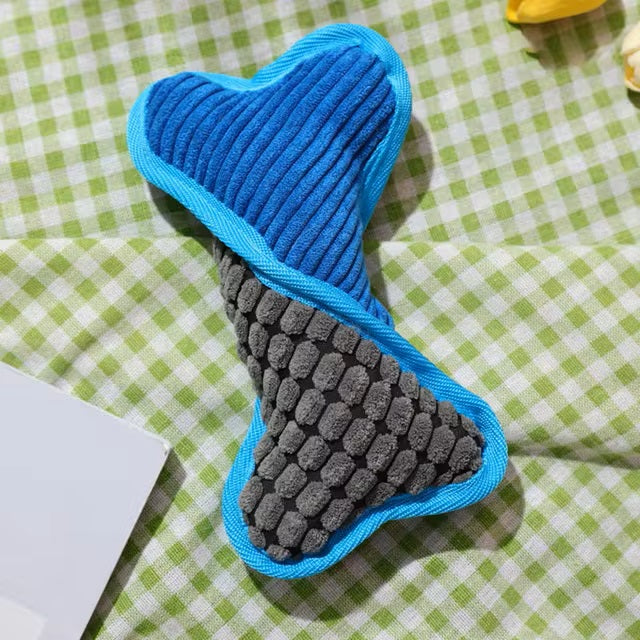 Weiches Hundespielzeug in Knochenform, blau-grau, auf kariertem Hintergrund. Perfekt für interaktives Spielen und Zahnpflege.