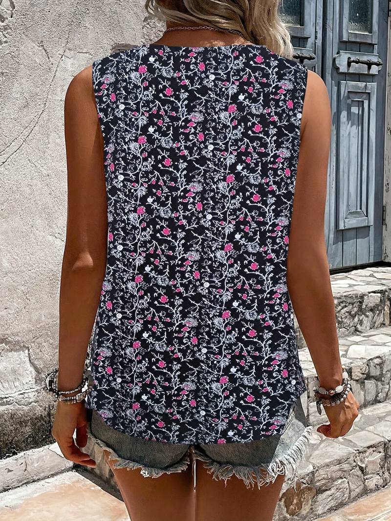 Ärmelloses Damen-Top mit floralem Muster, schwarz-weiß mit pinken Akzenten, ideal für Sommermode, kombiniert mit Jeansshorts.
