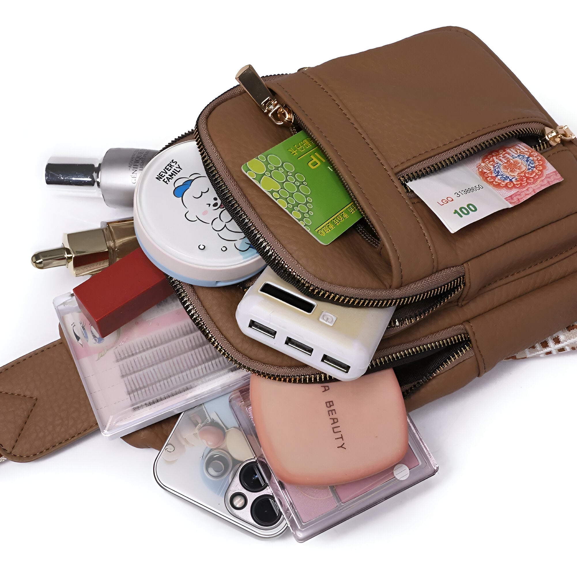 Braune Lederhandtasche mit Kosmetik, Geldscheinen und Smartphone-Zubehör, ideal für Damen.