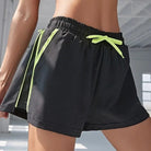 Schwarze Sportshorts mit neonfarbenem Kordelzug, ideal für Fitness und Freizeit. Atmungsaktiv, bequem und modisch für aktive Frauen.