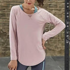 Rosa langärmliges Sporttop für Damen, ideal für Fitness und Yoga. Atmungsaktives Material, bequem und stilvoll. Perfekt für aktive Frauen.