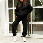 Schwarzes Sweatshirt-Set für Damen, lässig und bequem, ideal für Freizeit und Sport. Perfekt kombinierbar mit Sneakers. Trendige Mode 2023.