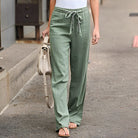 Damen Leinenhose in Grün, lässig und bequem, ideal für Sommermode. Perfekt kombiniert mit weißem Top und Sandalen für einen entspannten Look.