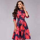 Elegantes, mittellanges Kleid mit roten Blumenmuster auf dunkelblauem Hintergrund. Perfekt für besondere Anlässe und stilvolle Auftritte.