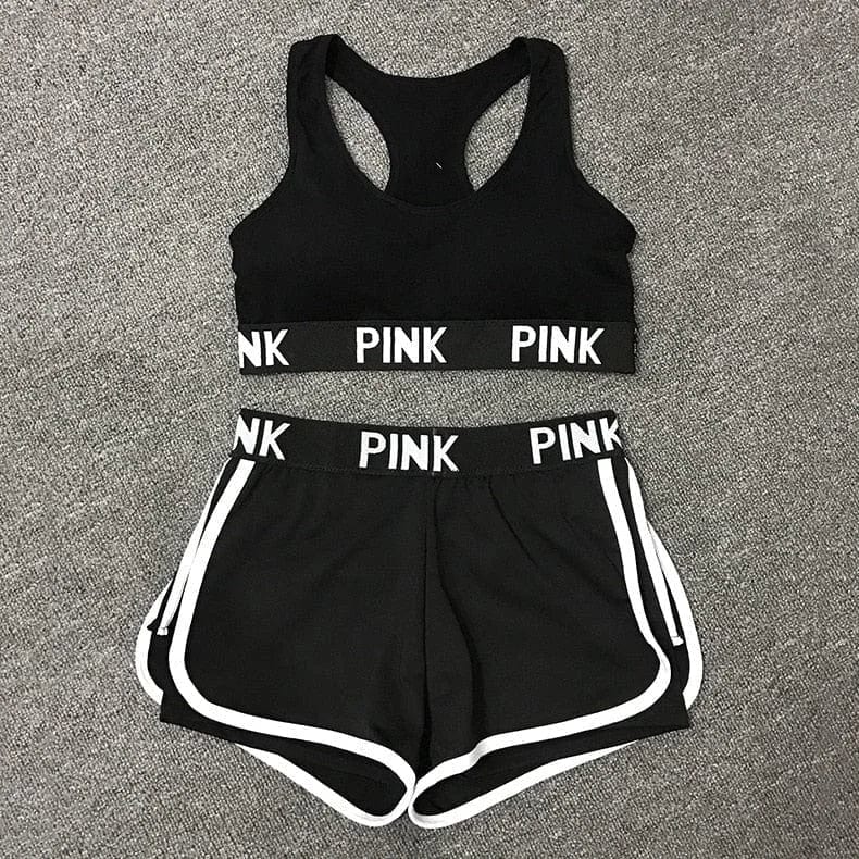 Schwarzes Sportset für Damen, bestehend aus Sport-BH und Shorts mit "PINK"-Aufschrift. Ideal für Fitness, Laufen und Yoga. Größe M.