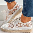 Stilvolle, luftige Damenschuhe mit Blumenmuster, ideal für den Sommer. Bequeme Sneaker mit weißem Spitzen-Design und geflochtener Sohle.