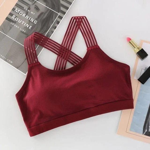 Sport-BH in Rotwein mit gekreuzten Trägern, ideal für Fitness und Yoga. Atmungsaktives Material, stilvolles Design, hoher Tragekomfort.
