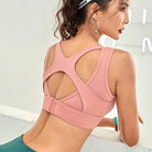 Rosa Sport-BH mit dekorativem Rückendesign, ideal für Fitness und Yoga. Atmungsaktives Material, bietet optimalen Halt und Komfort.