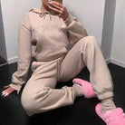 Beiges Sweatshirt-Set mit dekorativen Inschriften, gemütlich und modisch. Perfekt für Freizeit und Komfort. Ideal für trendige Loungewear-Looks.
